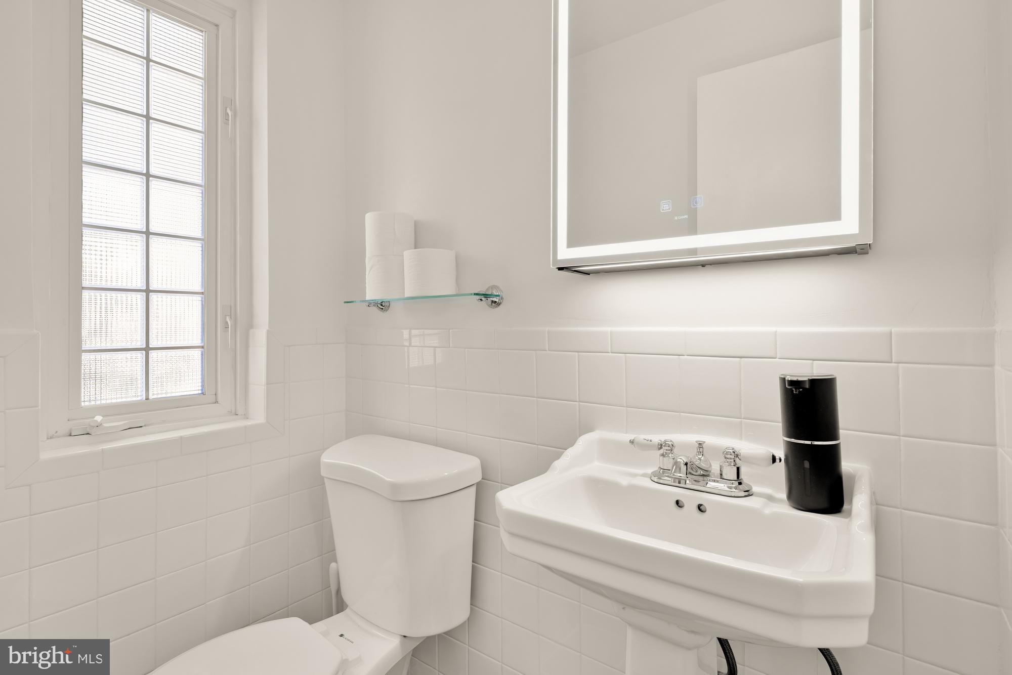 1736 Overlook Drive Silver Spring, MD 20903 - Photo 26 of 42 a bathroom with a sink a toilet and window