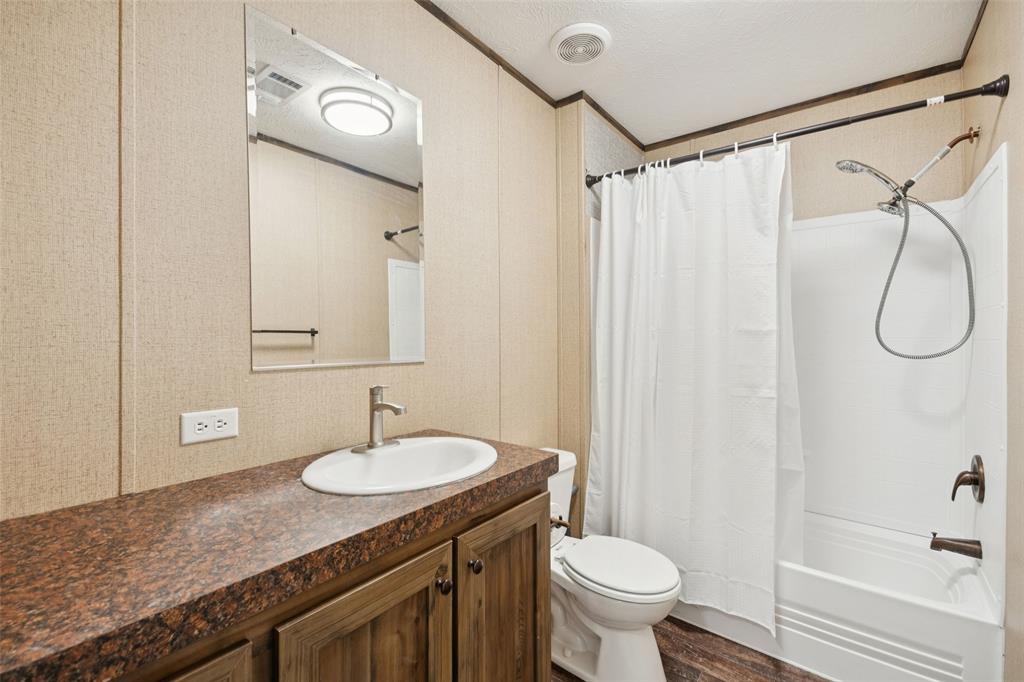 10240 Norrell Road Venus, TX 76084 - Photo 12 of 22 a bathroom with a granite countertop sink toilet and shower