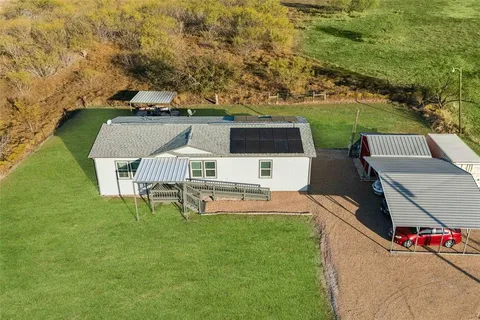 an aerial view of a house with swimming pool garden and patio