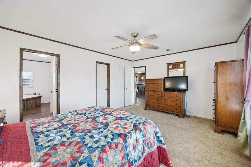 10240 Norrell Road Venus, TX 76084 - Photo 8 of 22 a bedroom with a bed and a flat screen tv