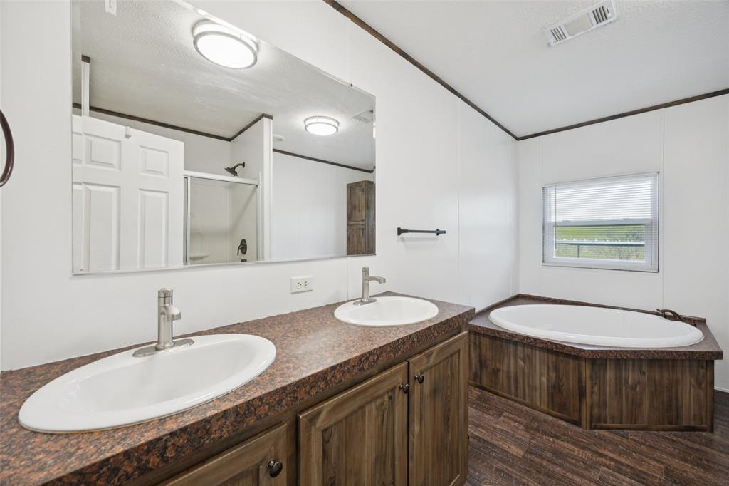 10240 Norrell Road Venus, TX 76084 - Photo 9 of 22 a bathroom with a granite countertop double vanity sink and a mirror