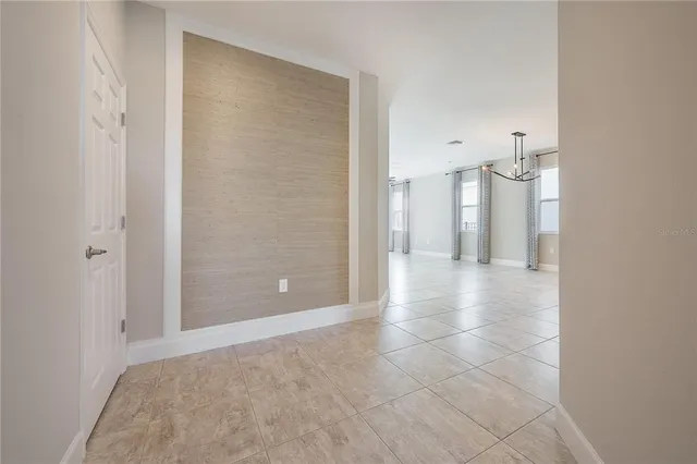 a view of a kitchen with a sink and a chandelier