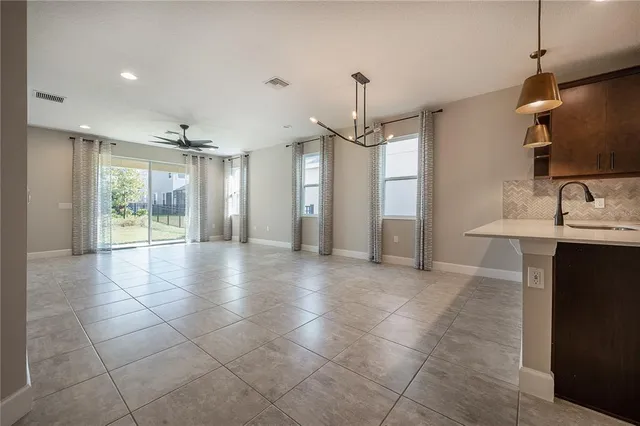 a view of a livingroom with a ceiling fan and window
