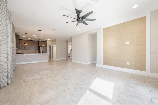 a kitchen with a refrigerator a sink and cabinets