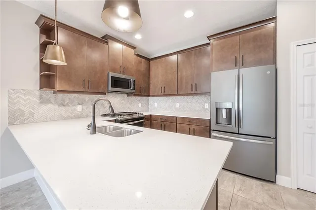 a kitchen with a sink and a refrigerator