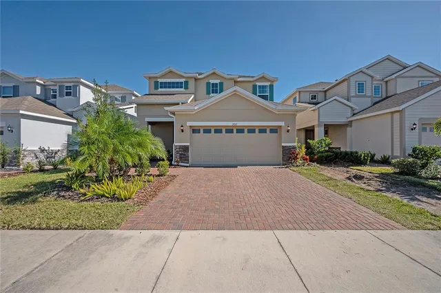 a front view of a house with a yard and garage