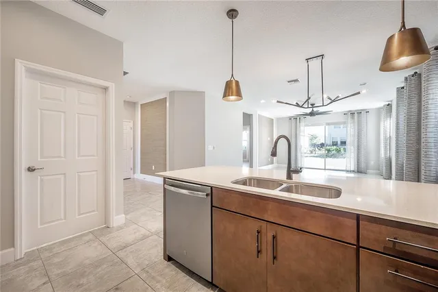 a view of a kitchen with a sink and white cabinets
