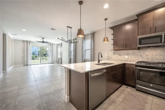 a view of a livingroom with a ceiling fan and window
