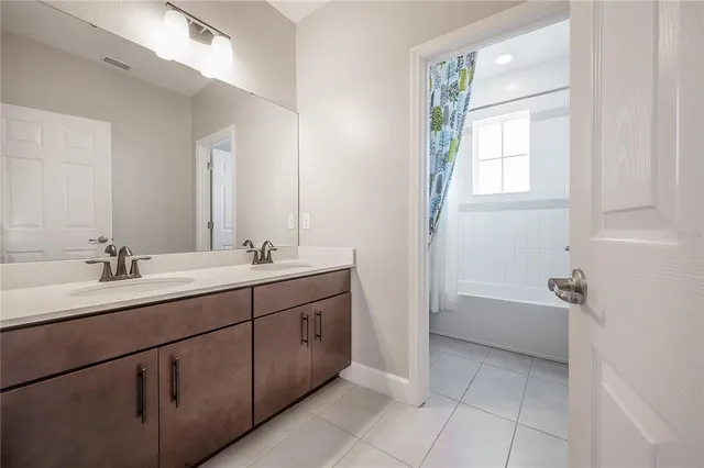 a view of a kitchen with a sink and a refrigerator