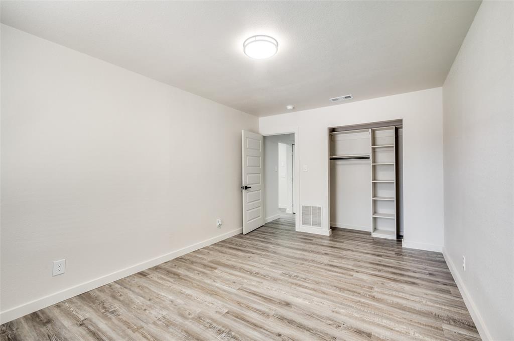 733 Southeast 3rd Street Grand Prairie, TX 75051 - Photo 15 of 24 Unfurnished bedroom featuring a closet and light wood-type flooring