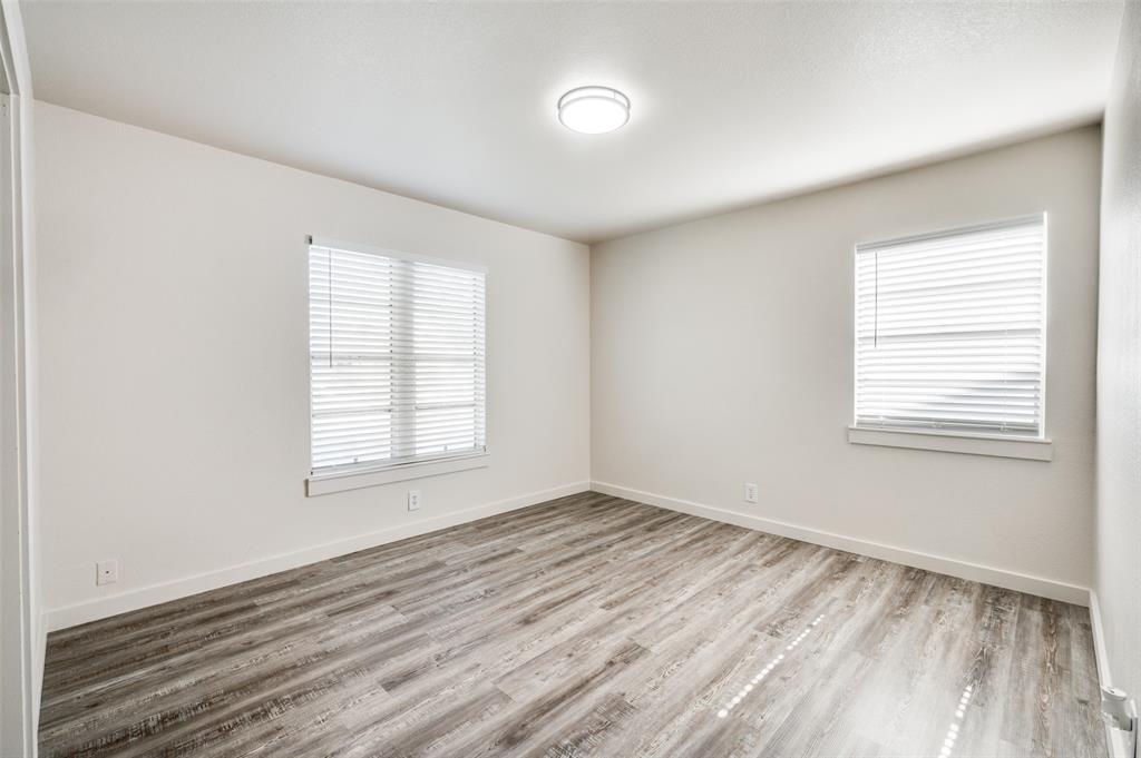 733 Southeast 3rd Street Grand Prairie, TX 75051 - Photo 17 of 24 Empty room with light wood-style floors and baseboards