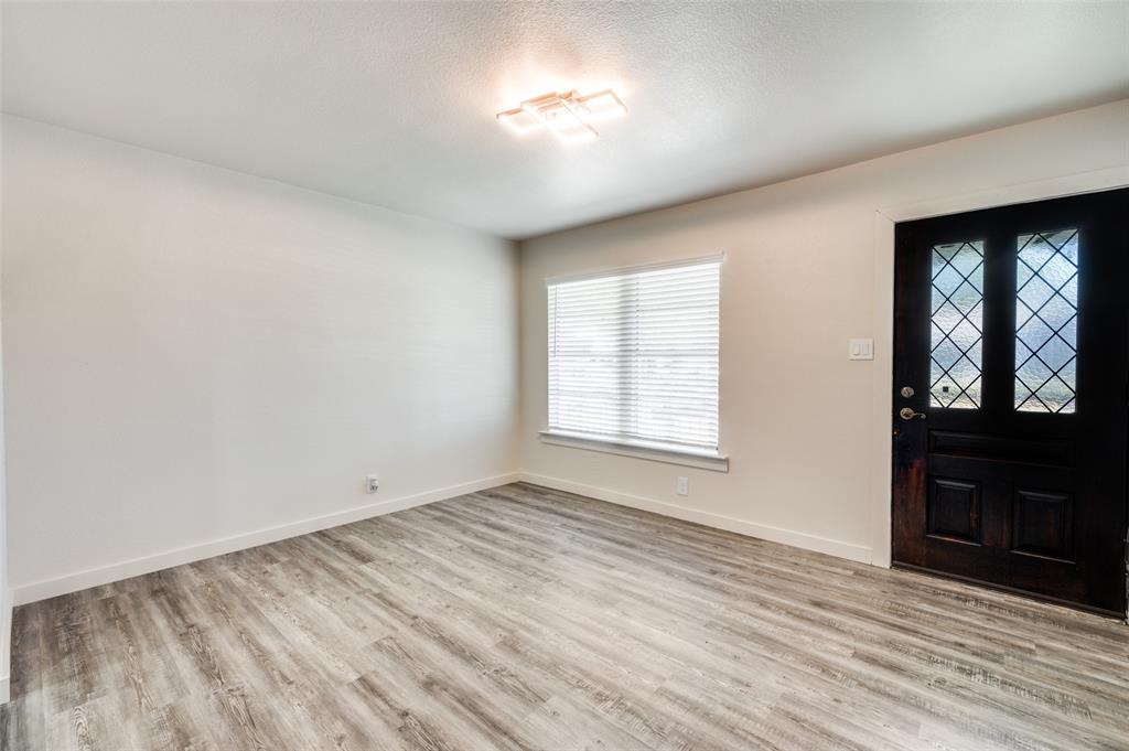 733 Southeast 3rd Street Grand Prairie, TX 75051 - Photo 2 of 24 Foyer featuring light wood-style flooring and a textured ceiling