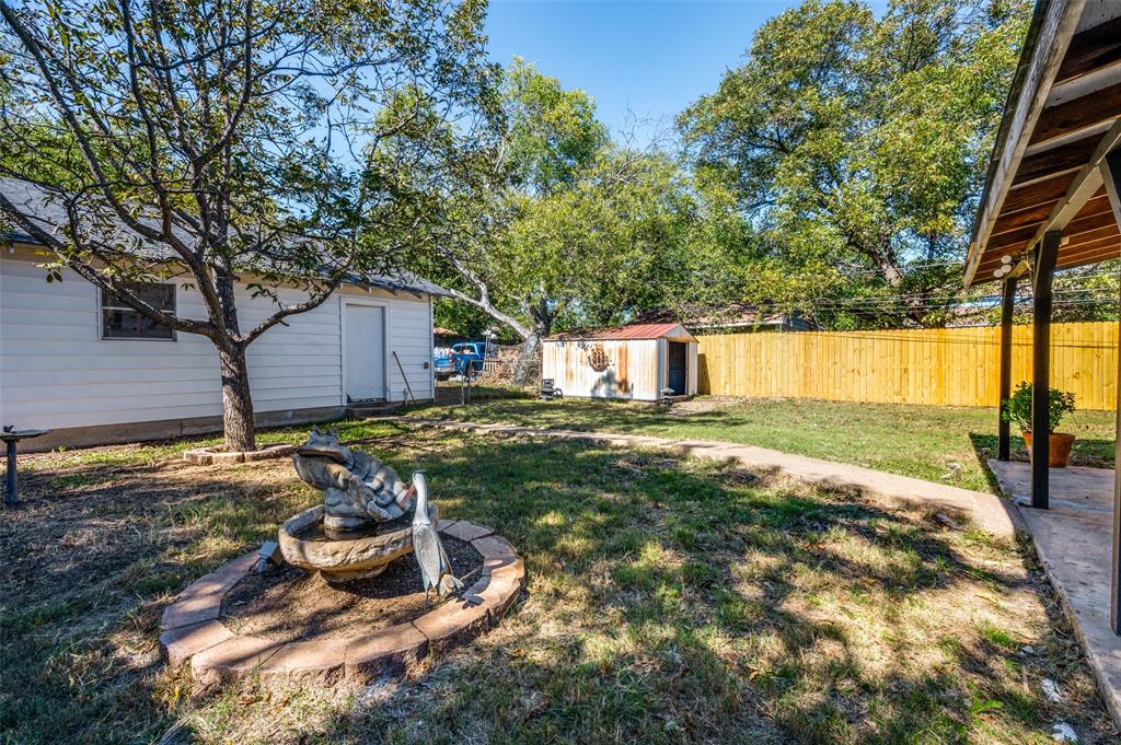 733 Southeast 3rd Street Grand Prairie, TX 75051 - Photo 21 of 24 Fenced backyard featuring a shed