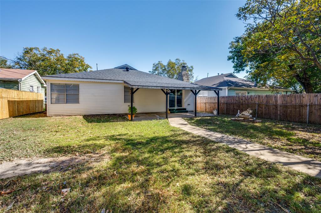 733 Southeast 3rd Street Grand Prairie, TX 75051 - Photo 22 of 24 Rear view of property featuring a fenced backyard, a chimney, a patio, and a shingled roof