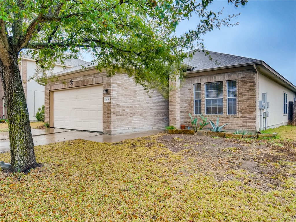105 Almquist Street Hutto, TX 78634 - Photo 1 of 1 a front view of a house with garden