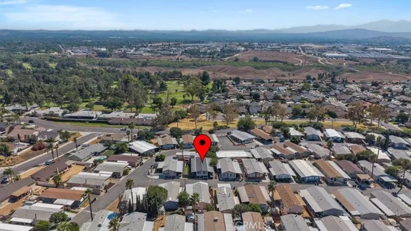 an aerial view of a house with a yard