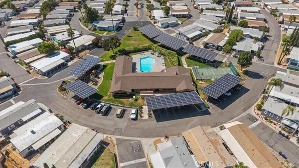 a view of a house with a small yard and sitting area