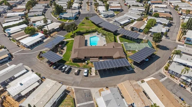 a view of a house with a small yard and sitting area