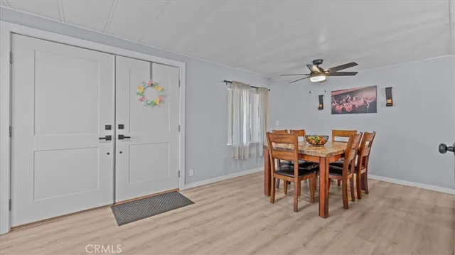a view of a dining room with furniture and a chandelier fan