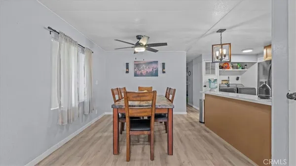 a kitchen with stainless steel appliances a sink cabinets and wooden floor