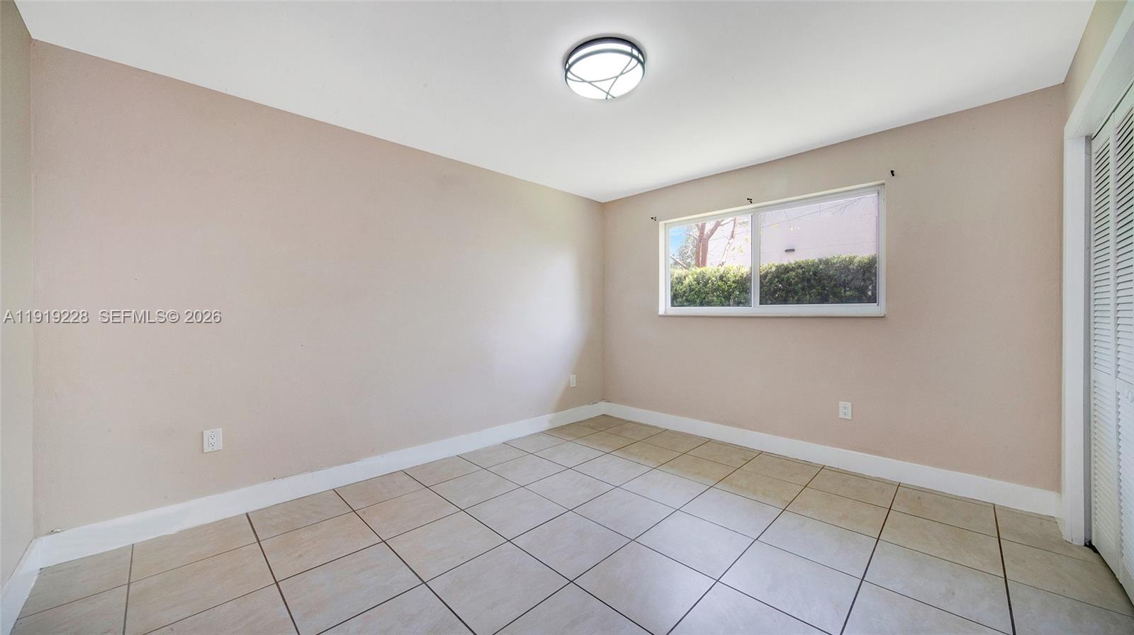 592 Northeast 150th Street, Unit 3 Miami, FL 33161 - Photo 15 of 22 an empty room with windows