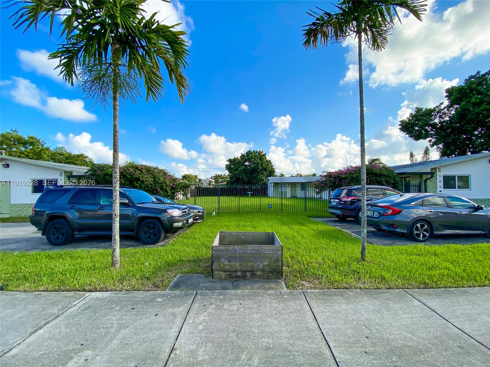 592 Northeast 150th Street, Unit 3 Miami, FL 33161 - Photo 22 of 22 a view of a garden with a slide and a fountain