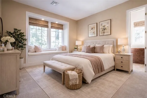 a bedroom with a bed and a large window