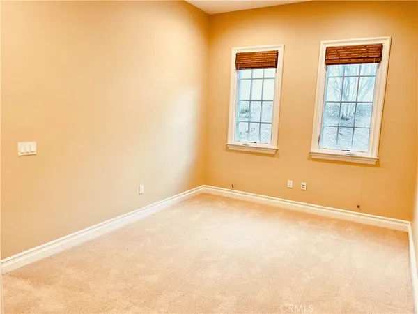 an empty room with a empty space and windows
