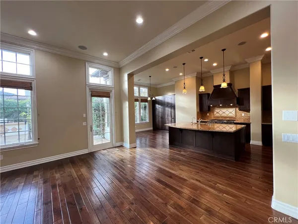 a view of a living room and kitchen with furniture floor to ceiling window