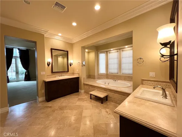 a large spacious bathroom with a large tub and sink