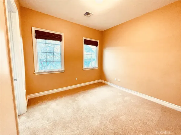 an empty room with windows and closet