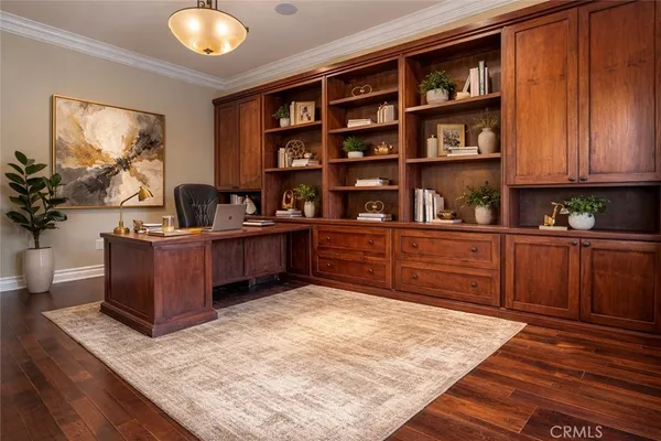 a view of a kitchen with furniture and wooden floor