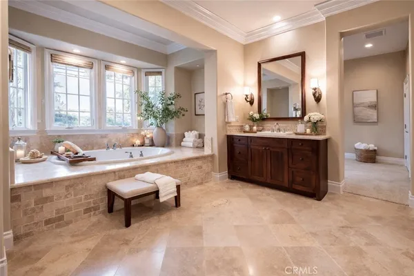 a spacious bathroom with a tub sink and mirror