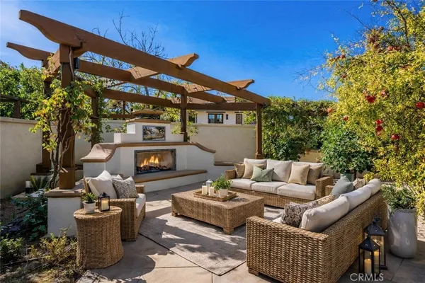 a view of a patio with couches and a fire pit and a fire pit