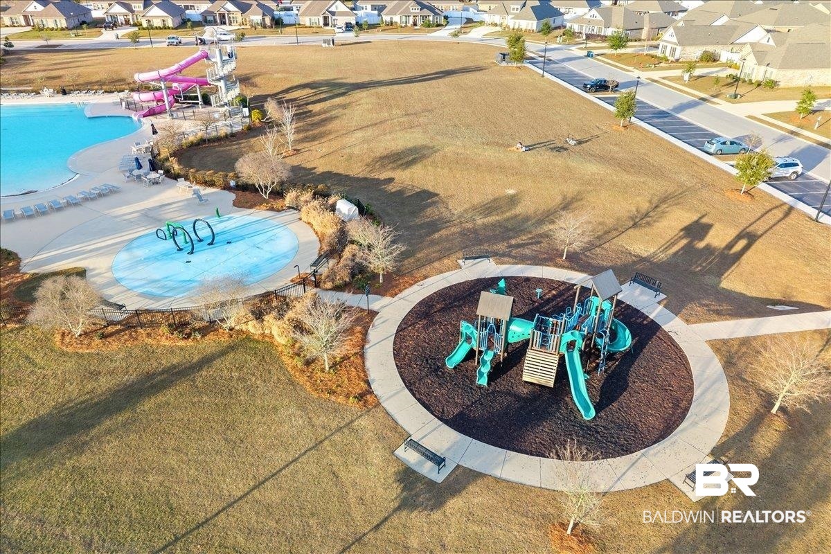 23641 Unbridled Loop Daphne, AL 36526 - Photo 35 of 40 Community amenities featuring a resort-style pool with waterslides, a splash pad, and a dedicated playground area