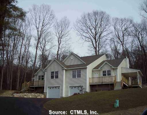 1077 Pleasant Valley Road North, Unit 13B Groton, CT 06340 - Photo 1 of 1 a front view of a house with a yard and garage