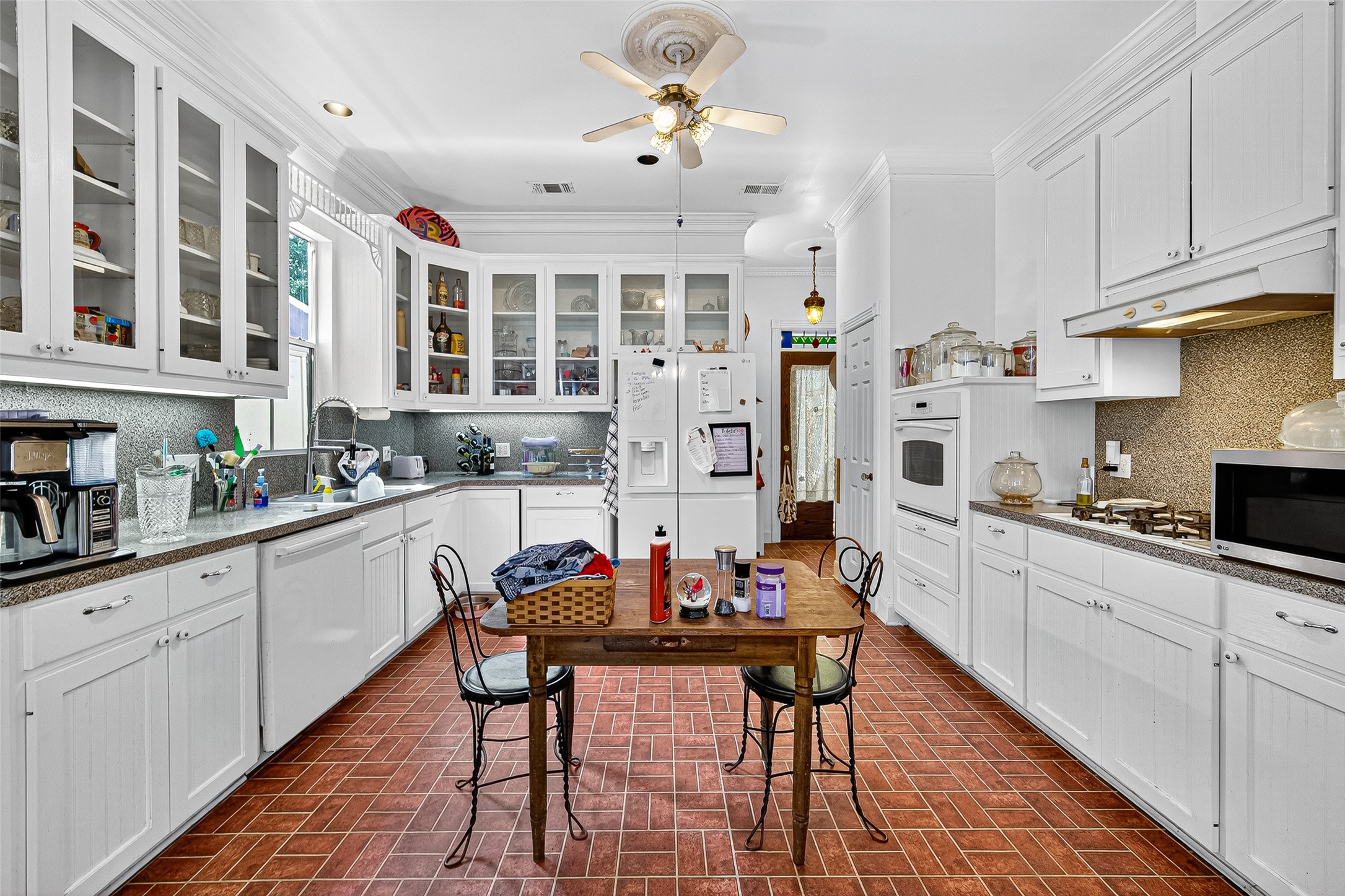 10116 Brighton Lane Houston, TX 77031 - Photo 17 of 50 a kitchen with stainless steel appliances kitchen island granite countertop a table chairs sink and cabinets