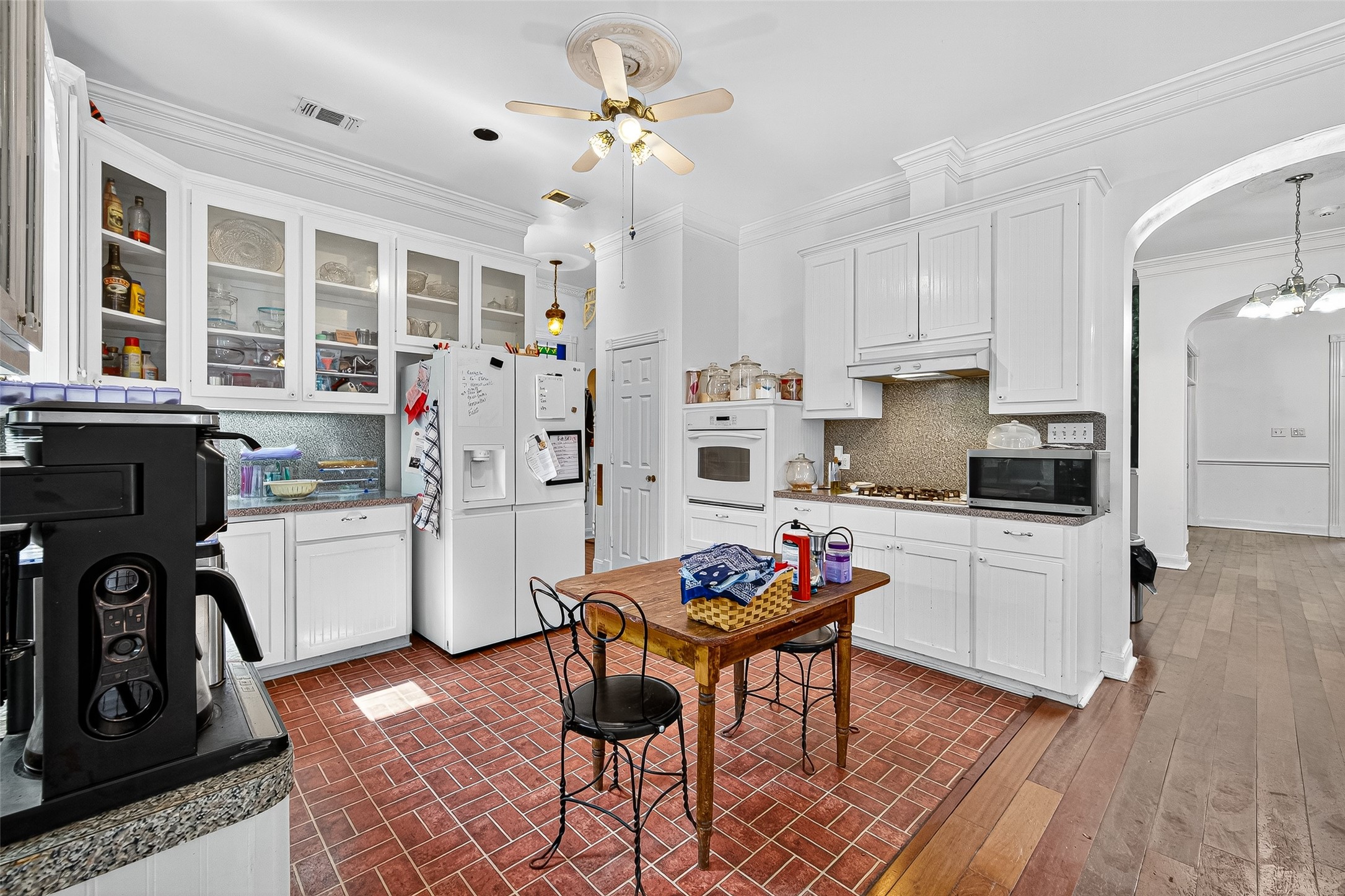 10116 Brighton Lane Houston, TX 77031 - Photo 26 of 50 a kitchen with stainless steel appliances kitchen island granite countertop a refrigerator a stove a sink dishwasher and a stove with wooden floor