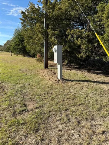a view of a yard with wooden fence