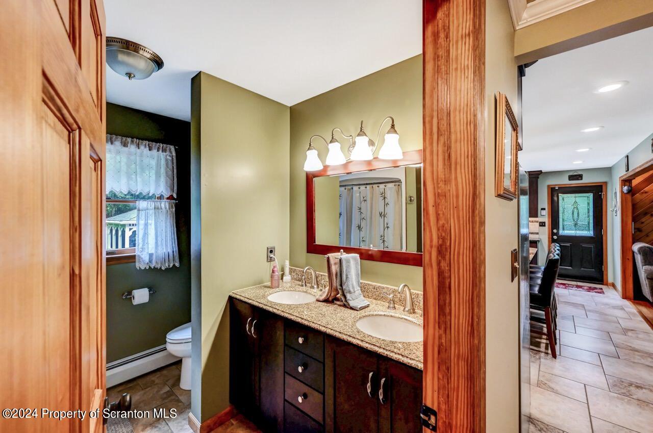 755 Spring Hill Road Sterling, PA 18463 - Photo 26 of 99 a bathroom with a double vanity sink and a mirror