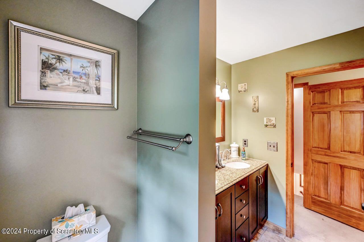 755 Spring Hill Road Sterling, PA 18463 - Photo 29 of 99 a bathroom with a double vanity sink and a mirror