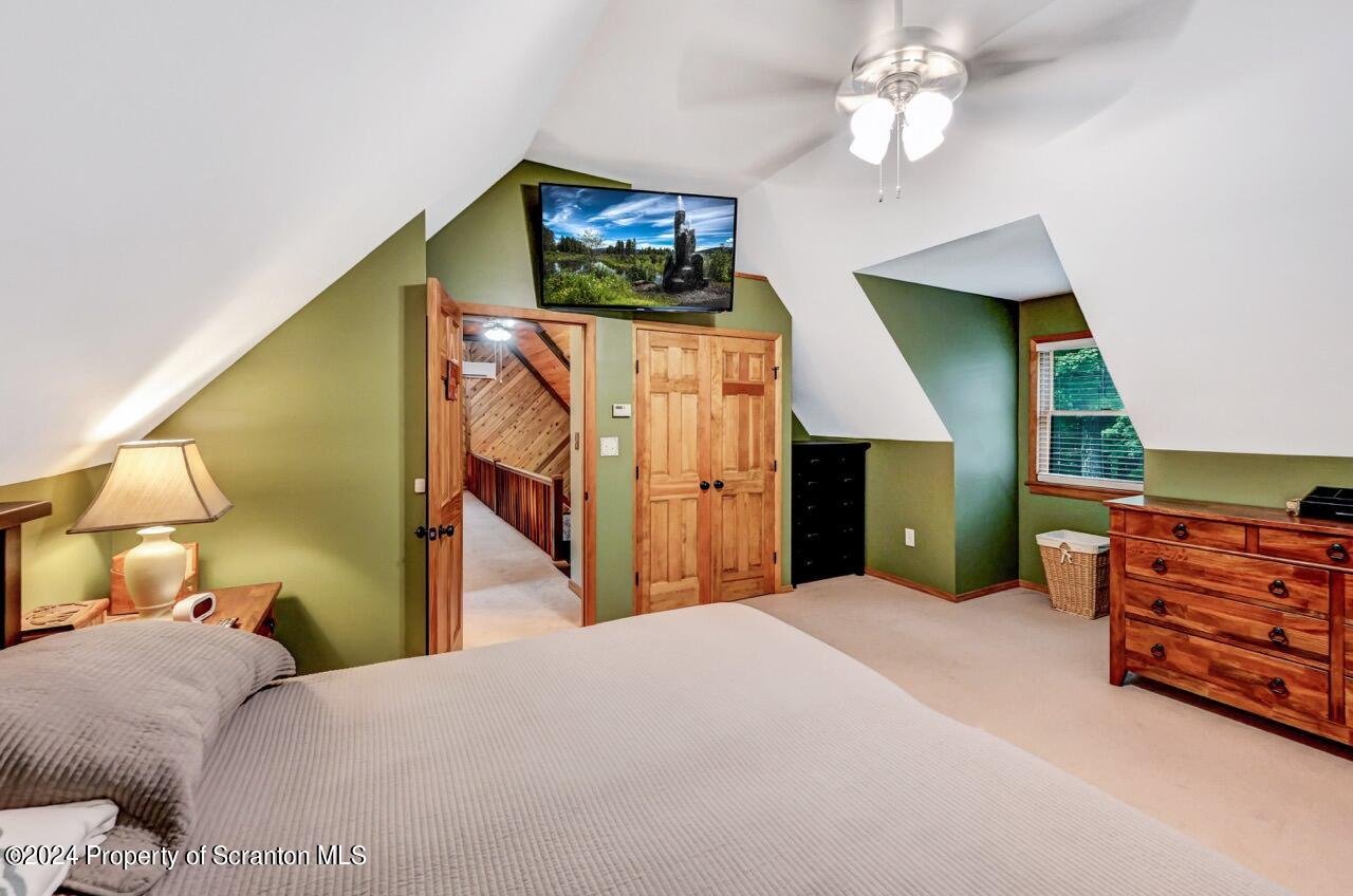 755 Spring Hill Road Sterling, PA 18463 - Photo 45 of 99 a bedroom with a bed and a flat screen tv