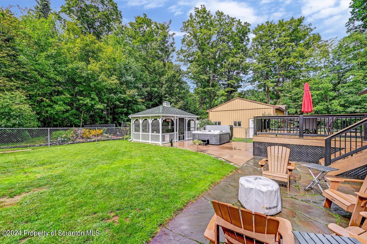 755 Spring Hill Road Sterling, PA 18463 - Photo 66 of 99 a view of a house with backyard sitting area and garden