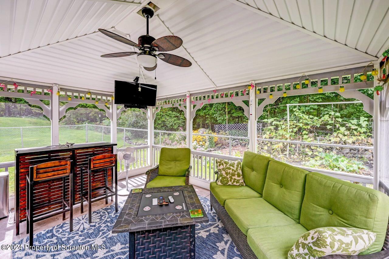 755 Spring Hill Road Sterling, PA 18463 - Photo 71 of 99 a living room with patio furniture and a floor to ceiling window