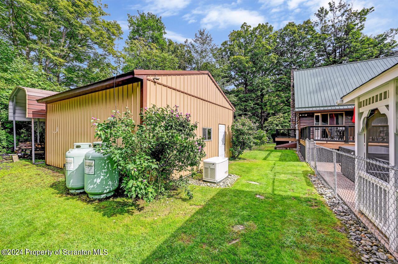 755 Spring Hill Road Sterling, PA 18463 - Photo 74 of 99 a backyard of a house with plants and outdoor seating