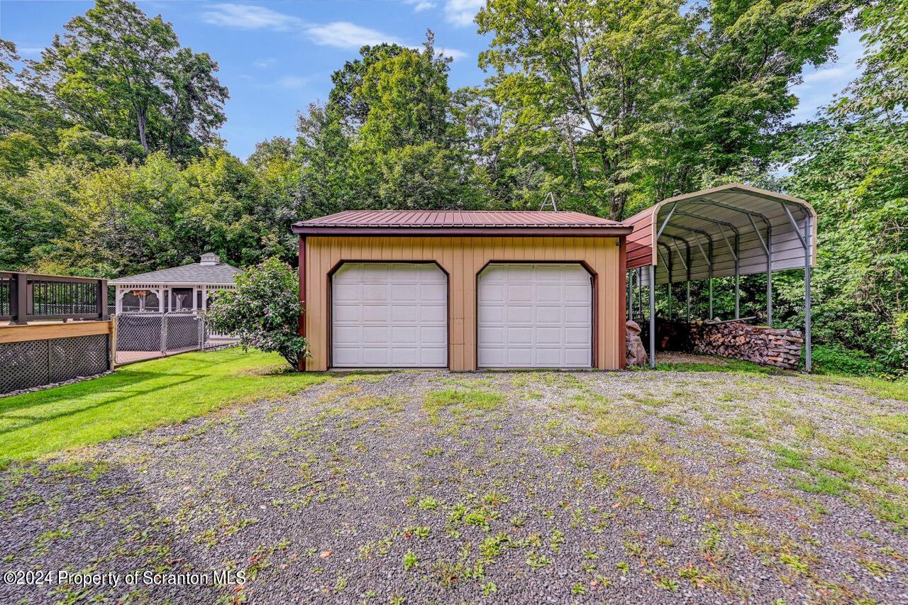 755 Spring Hill Road Sterling, PA 18463 - Photo 76 of 99 a front view of a house with garden