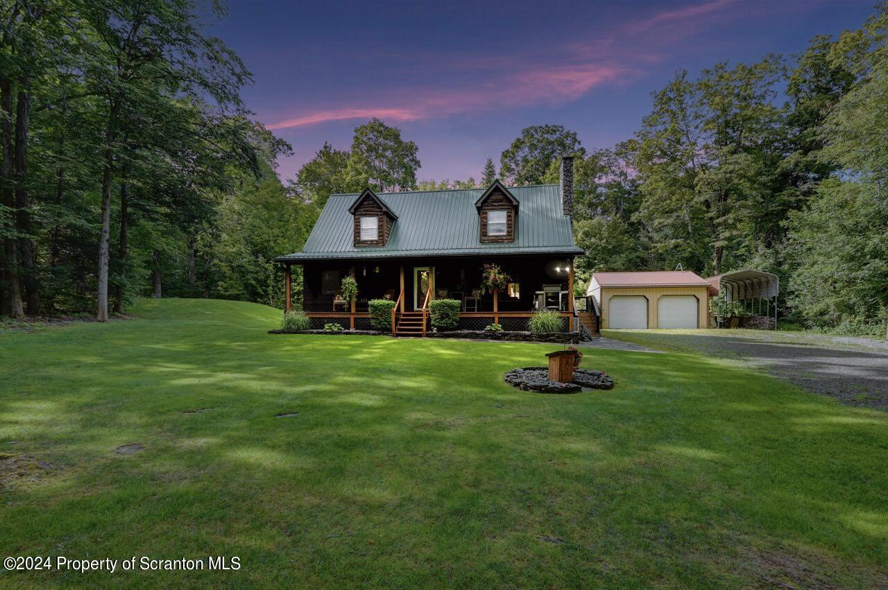 755 Spring Hill Road Sterling, PA 18463 - Photo 86 of 99 a front view of a house with a yard table and chairs