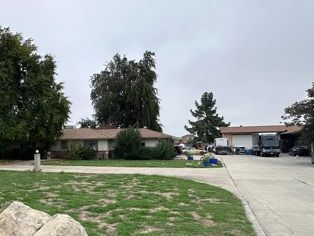 a front view of a house with a yard table and chairs
