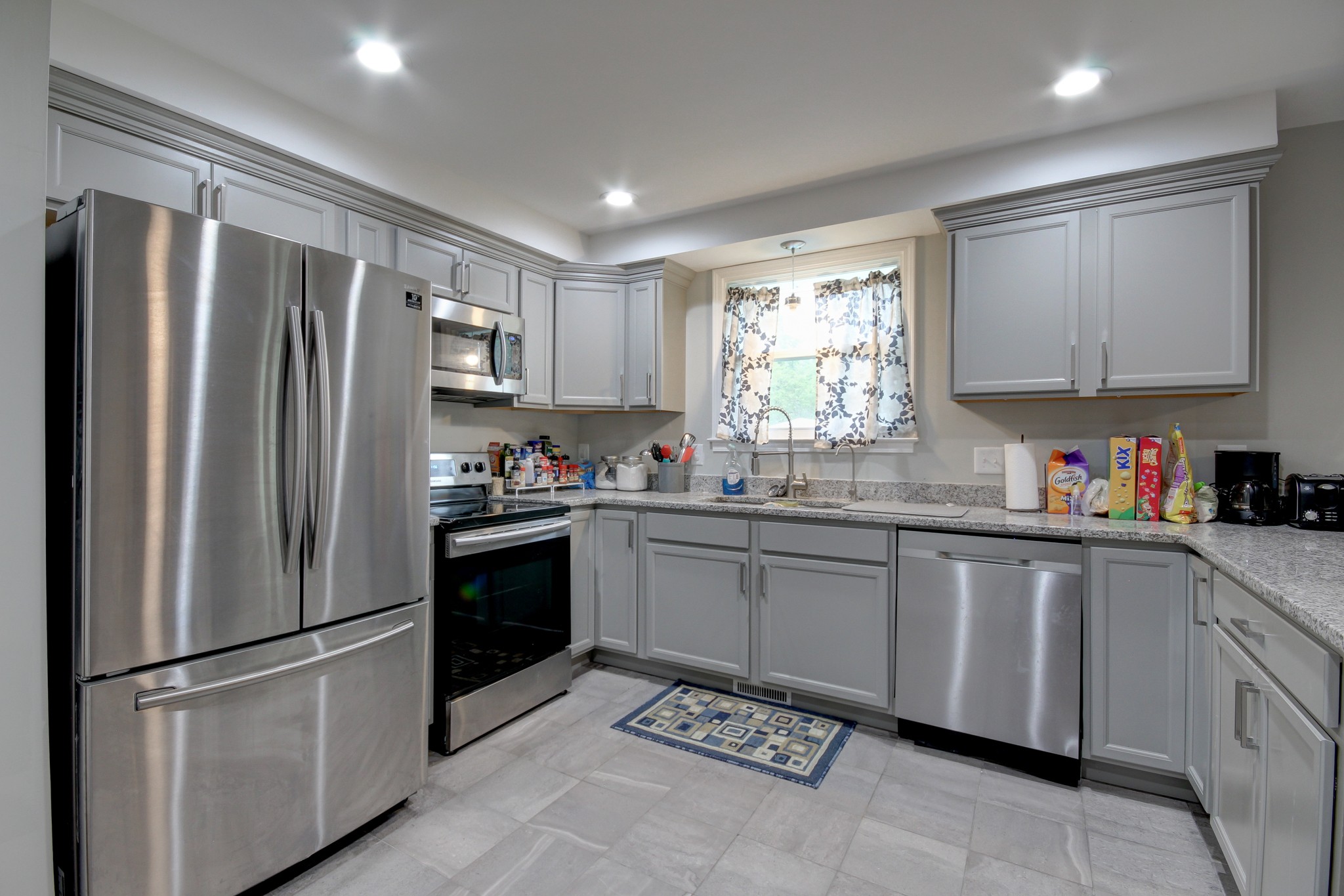 309 Burch Road Clarksville, TN 37042 - Photo 5 of 12 a kitchen with granite countertop stainless steel appliances a refrigerator sink and microwave
