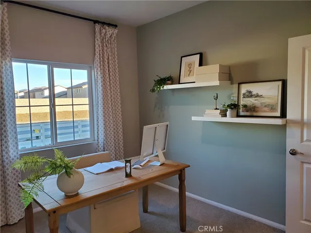 a workspace with furniture and window